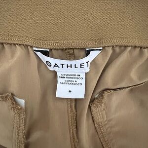 Wide leg pleated trousers with zippered pockets by Athleta